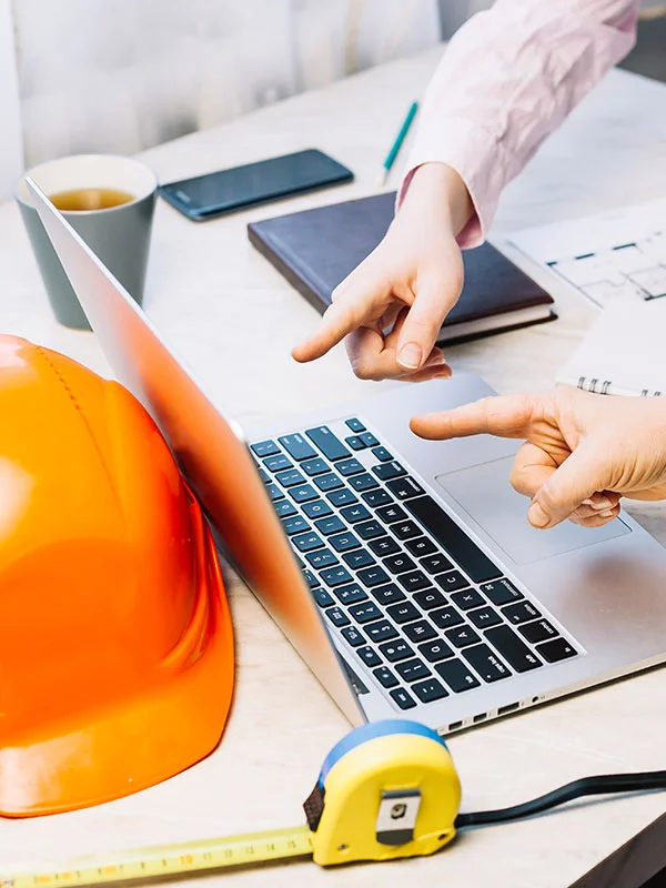 Project management meeting during a construction project, people pointing at a computer